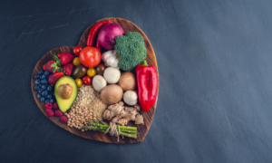 Heart shaped bowl filled with heart healthy foods