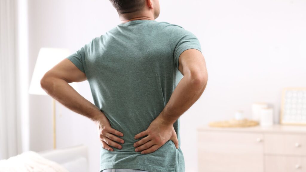 Pain Awareness Month- Man holding lower back in pain